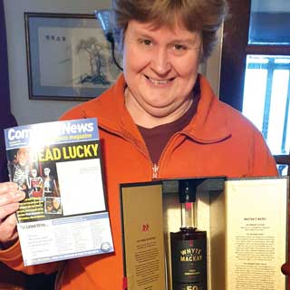 Amanda with her prize of a £5,000 bottle of rare whisky
